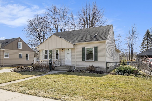 bungalow-style home featuring a shingled roof, a front lawn, and fence
