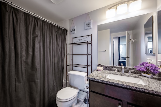bathroom featuring toilet, a shower with curtain, and vanity