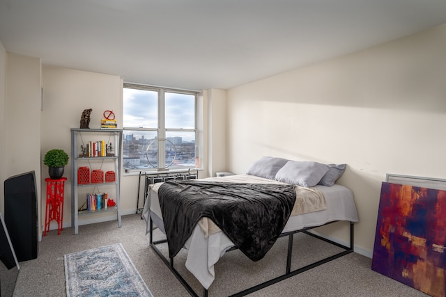 bedroom with light carpet and baseboards