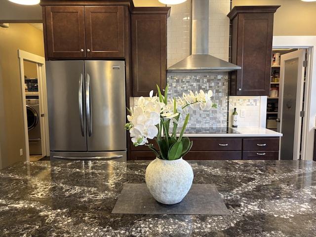 3269 Hopewell Ct NE, Rockford, MI 49341 - kitchen featuring freestanding refrigerator, wall chimney exhaust hood, black electric stovetop, dark brown cabinets, and backsplash