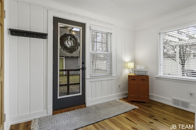 1200 Beach Dr, Holland, MI 49423 - doorway to outside featuring wood finished floors, healthy amount of natural light, and baseboards