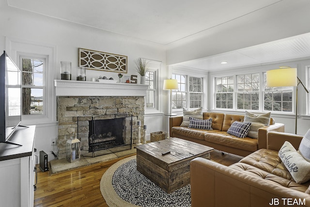 1200 Beach Dr, Holland, MI 49423 - living area with wood finished floors, healthy amount of natural light, and a stone fireplace
