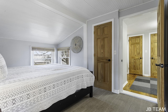 1200 Beach Dr, Holland, MI 49423 - bedroom featuring lofted ceiling, carpet flooring, and baseboards