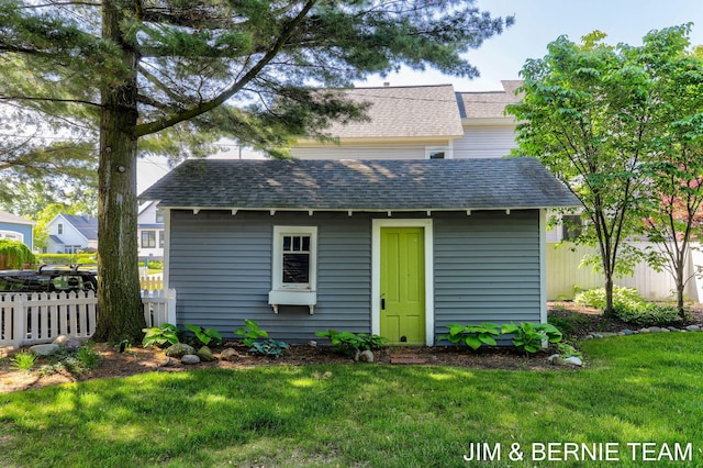 1200 Beach Dr, Holland, MI 49423 - rear view of property with a shingled roof and an outbuilding