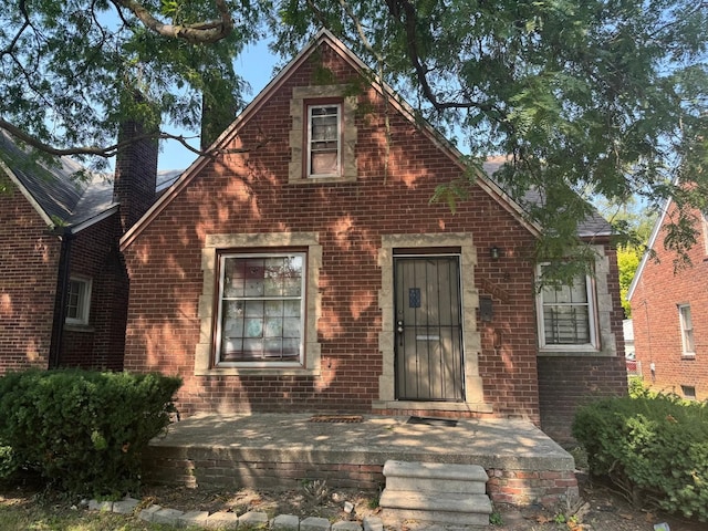 15613 Seymour St, Detroit, MI 48205 - view of front of house featuring brick siding and a chimney