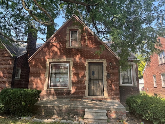 15613 Seymour St, Detroit, MI 48205 - view of front of home with brick siding and a chimney