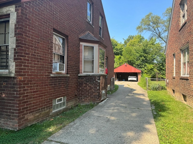 15613 Seymour St, Detroit, MI 48205 - view of side of property featuring brick siding, a detached garage, an outbuilding, and fence