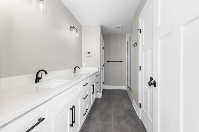 144 9 Mile Rd NW, Comstock Park, MI 49321 - full bathroom featuring a stall shower, tile patterned floors, double vanity, and baseboards