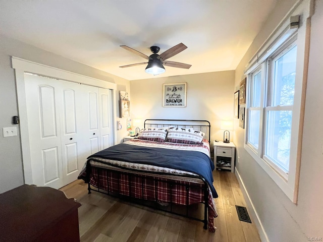 13936 Allen Rd, Clinton, MI 49236 - bedroom with a closet, ceiling fan, visible vents, baseboards, and wood finished floors