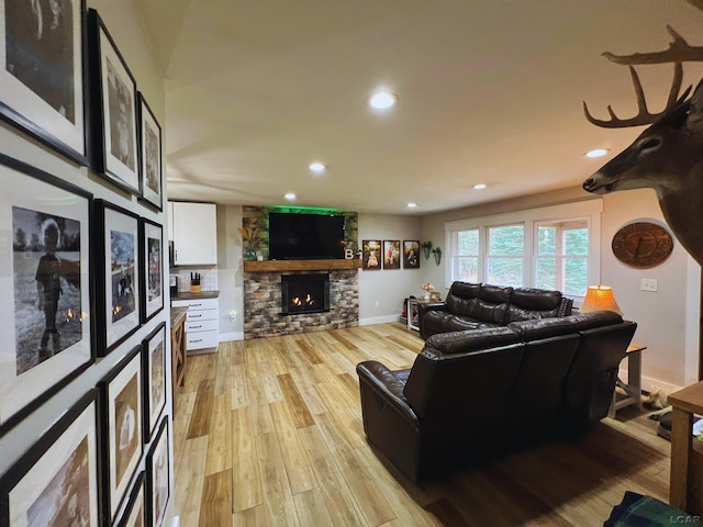 13936 Allen Rd, Clinton, MI 49236 - living room with baseboards, light wood-type flooring, a stone fireplace, and recessed lighting