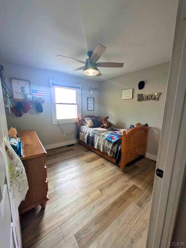 13936 Allen Rd, Clinton, MI 49236 - bedroom featuring baseboards, ceiling fan, and light wood-style flooring