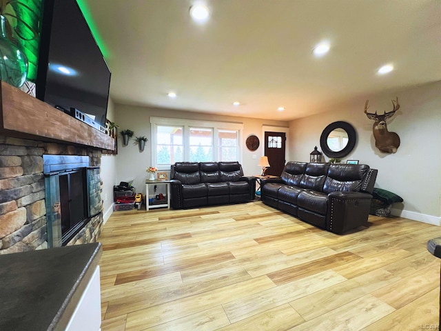 13936 Allen Rd, Clinton, MI 49236 - living room with a fireplace, recessed lighting, light wood-style flooring, and baseboards