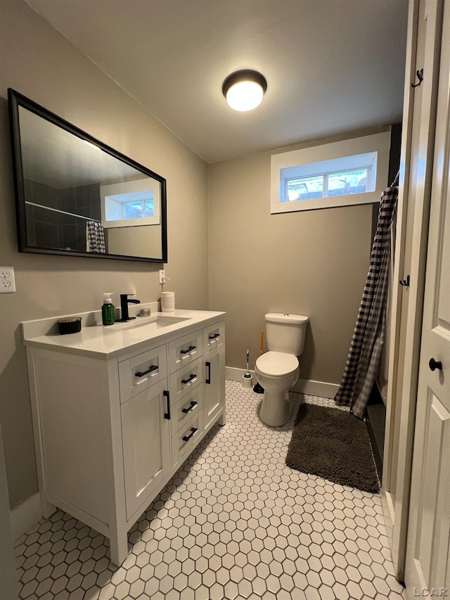 13936 Allen Rd, Clinton, MI 49236 - bathroom with toilet, a shower with shower curtain, vanity, and baseboards