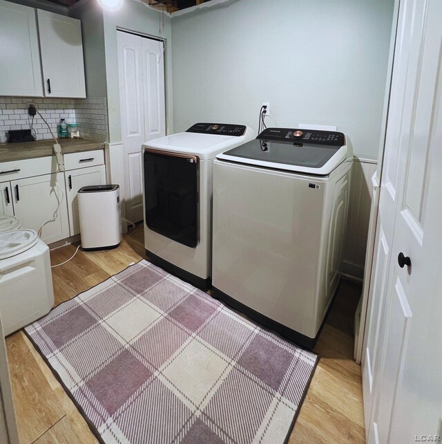13936 Allen Rd, Clinton, MI 49236 - washroom with light wood-style flooring and independent washer and dryer
