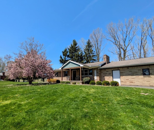 13936 Allen Rd, Clinton, MI 49236 - ranch-style house with a front lawn, brick siding, covered porch, and a chimney
