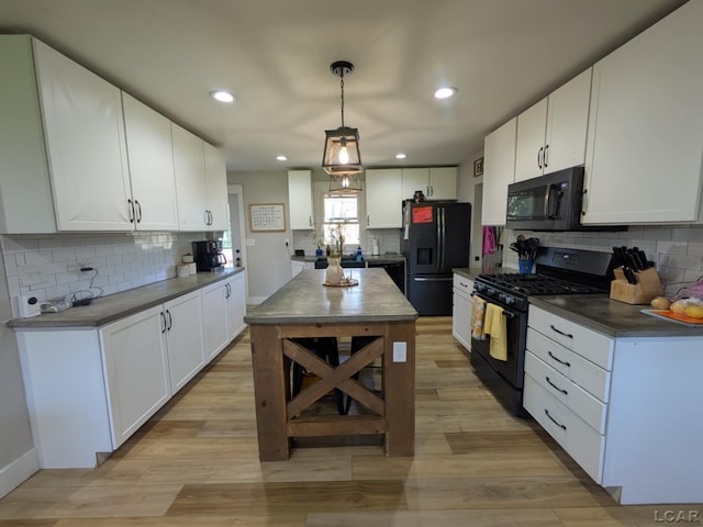 13936 Allen Rd, Clinton, MI 49236 - kitchen with black appliances, white cabinetry, decorative backsplash, and light wood-style flooring