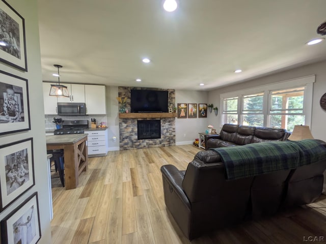 13936 Allen Rd, Clinton, MI 49236 - living room with a fireplace, light wood-style floors, recessed lighting, and baseboards