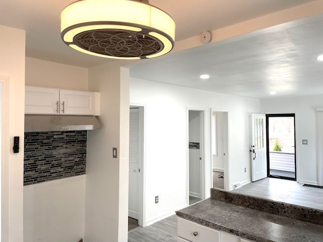 interior space featuring wood finished floors, baseboards, and recessed lighting