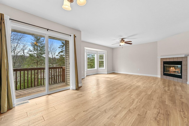 unfurnished living room featuring visible vents, baseboards, light wood-style floors, and ceiling fan