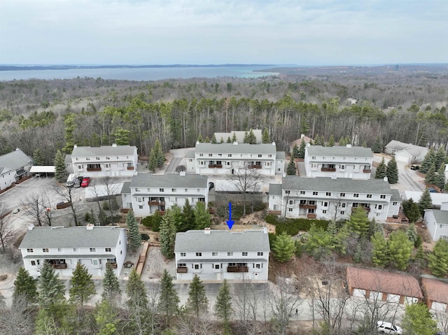 birds eye view of property featuring a view of trees