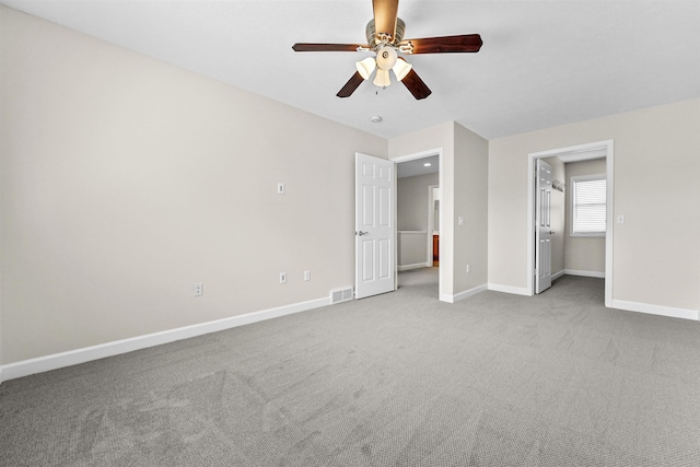 unfurnished bedroom with visible vents, baseboards, carpet, and a ceiling fan