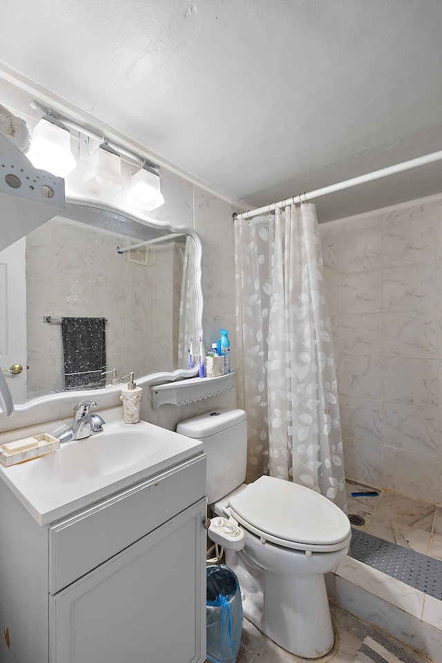 full bathroom featuring a shower stall, toilet, and vanity