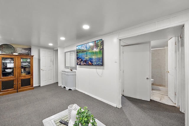 interior space featuring recessed lighting, dark colored carpet, and baseboards