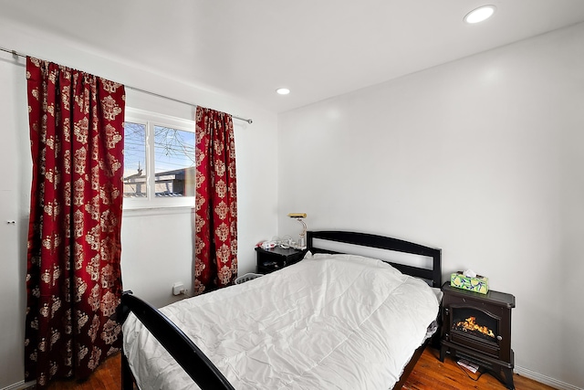 bedroom with wood finished floors and recessed lighting