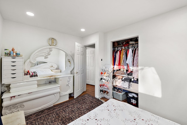 bedroom with recessed lighting, a closet, and wood finished floors