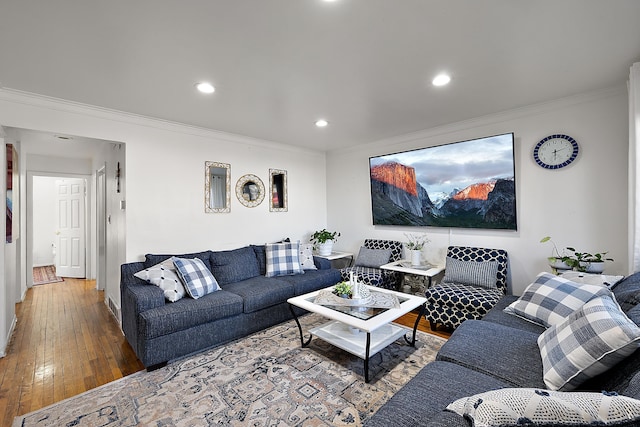 living room featuring recessed lighting, hardwood / wood-style flooring, and ornamental molding