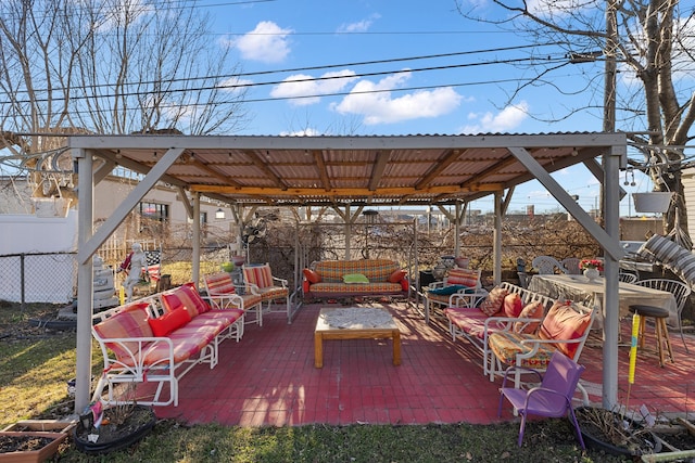 view of patio with an outdoor living space and fence