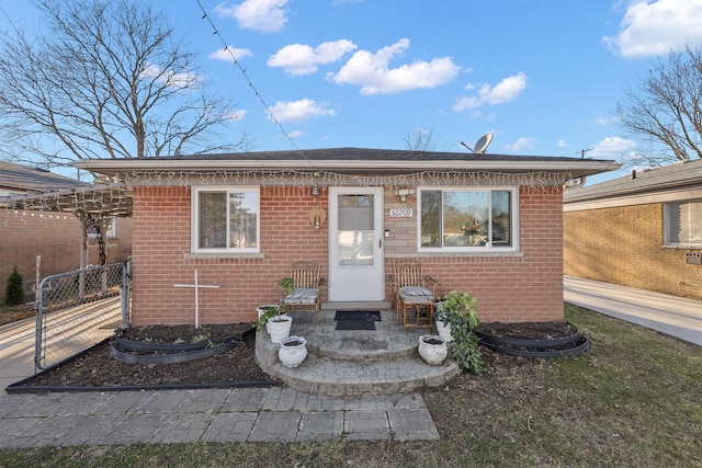 bungalow-style house featuring brick siding