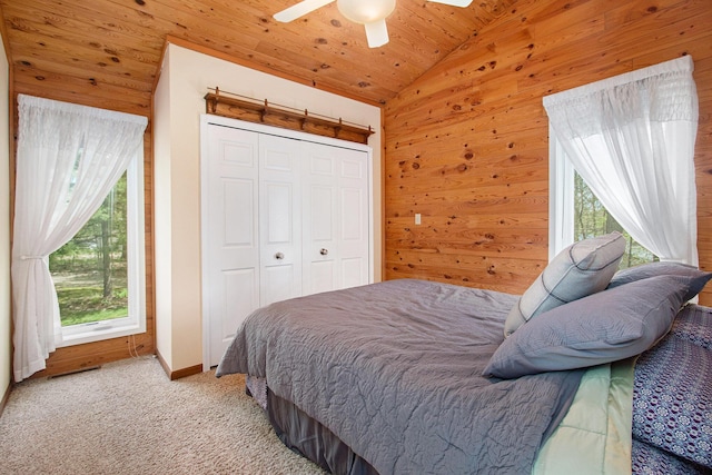 47463 Lakeview Dr, Lawrence, MI 49064 - carpeted bedroom with vaulted ceiling, wood ceiling, wood walls, ceiling fan, and a closet
