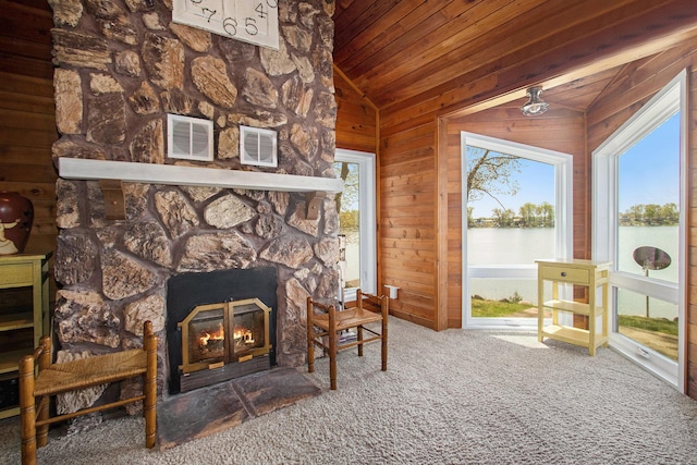 47463 Lakeview Dr, Lawrence, MI 49064 - sitting room with an outdoor stone fireplace, vaulted ceiling, wood ceiling, a water view, and carpet flooring