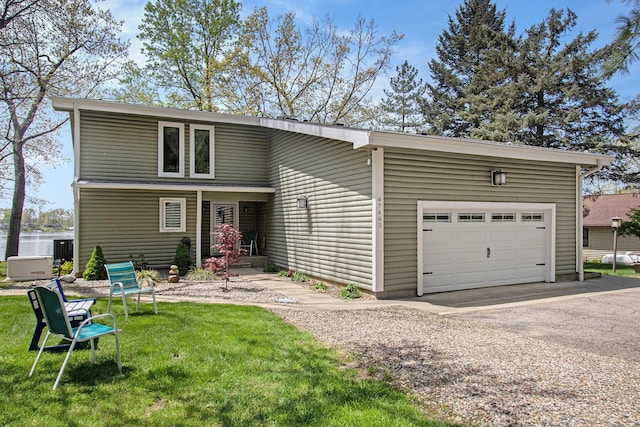 47463 Lakeview Dr, Lawrence, MI 49064 - view of front of house with driveway, a garage, a front lawn, and central AC unit