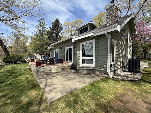 47463 Lakeview Dr, Lawrence, MI 49064 - rear view of property with central AC unit, a chimney, a lawn, and a patio