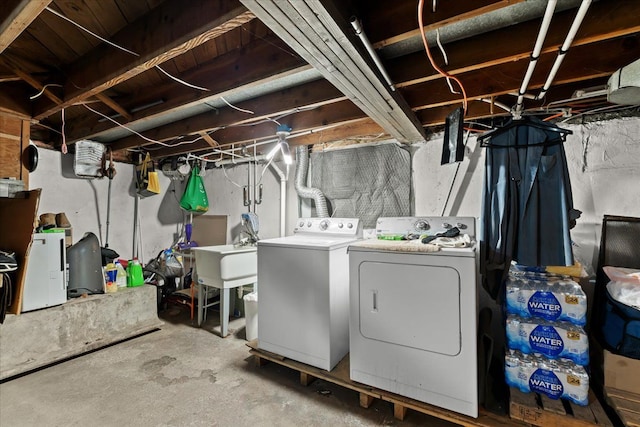unfinished below grade area with independent washer and dryer and a sink
