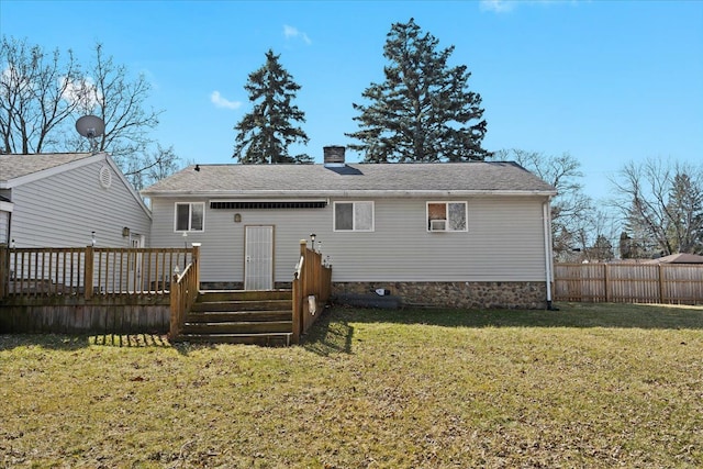back of house with a yard, fence, a chimney, and a wooden deck