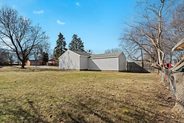 view of yard with an outdoor structure and fence