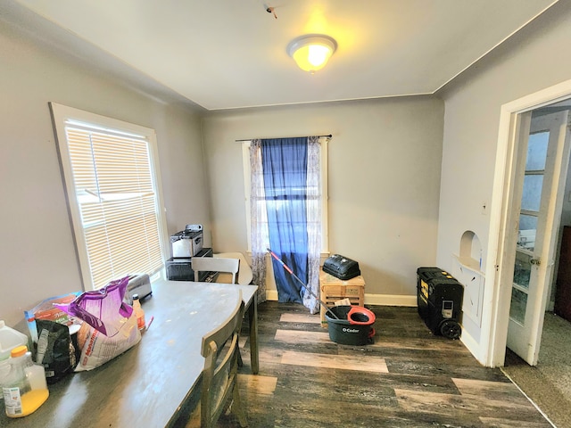 dining area featuring baseboards and wood finished floors