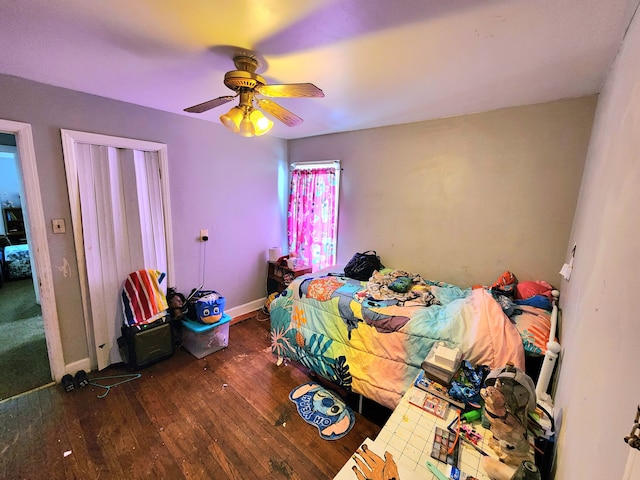 bedroom with hardwood / wood-style floors, ceiling fan, and baseboards