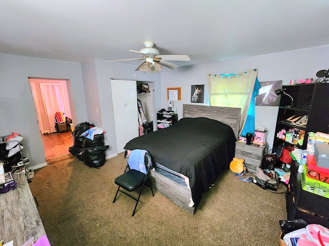 bedroom with a closet, baseboards, carpet, and a ceiling fan