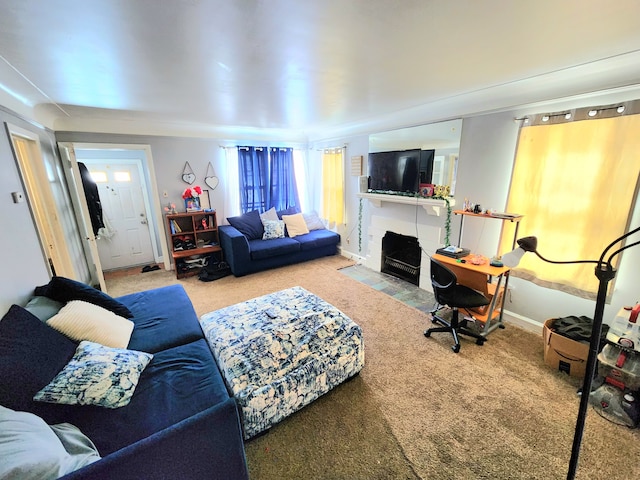 carpeted living area with a fireplace with flush hearth and baseboards