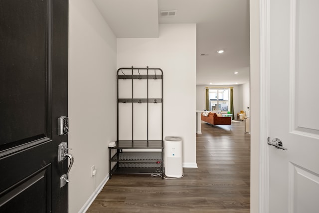 hall with dark wood-style floors, visible vents, baseboards, and recessed lighting