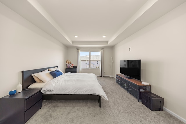 bedroom with baseboards, a tray ceiling, recessed lighting, and light colored carpet