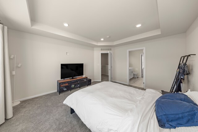 bedroom with carpet flooring, visible vents, baseboards, recessed lighting, and a raised ceiling
