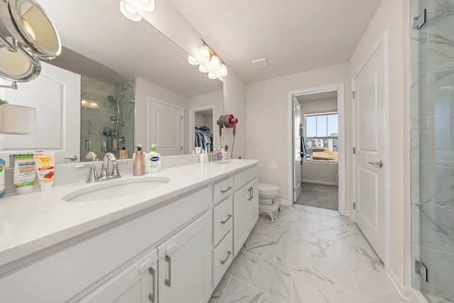 full bath featuring a walk in closet, a shower stall, marble finish floor, a sink, and double vanity