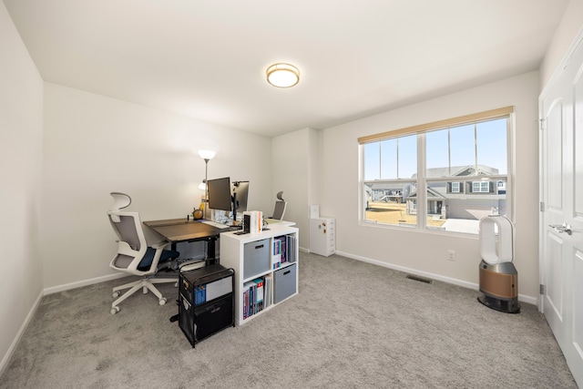 office space with baseboards, visible vents, and carpet