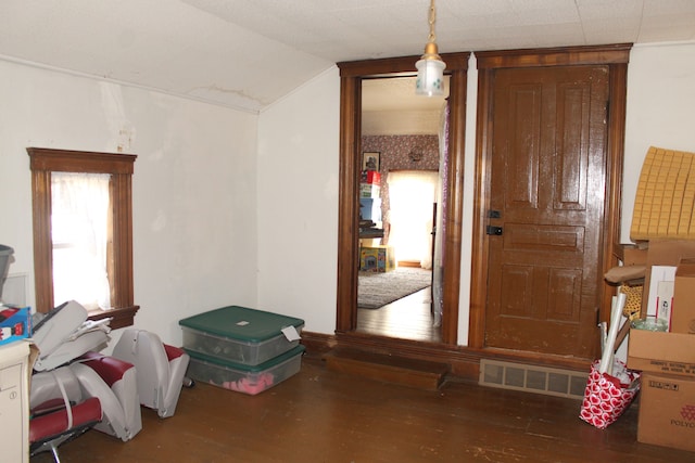 misc room featuring lofted ceiling, visible vents, and wood finished floors