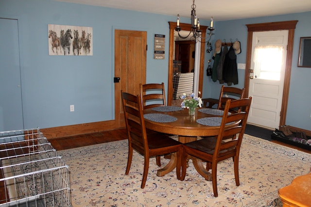 dining space with baseboards and wood finished floors